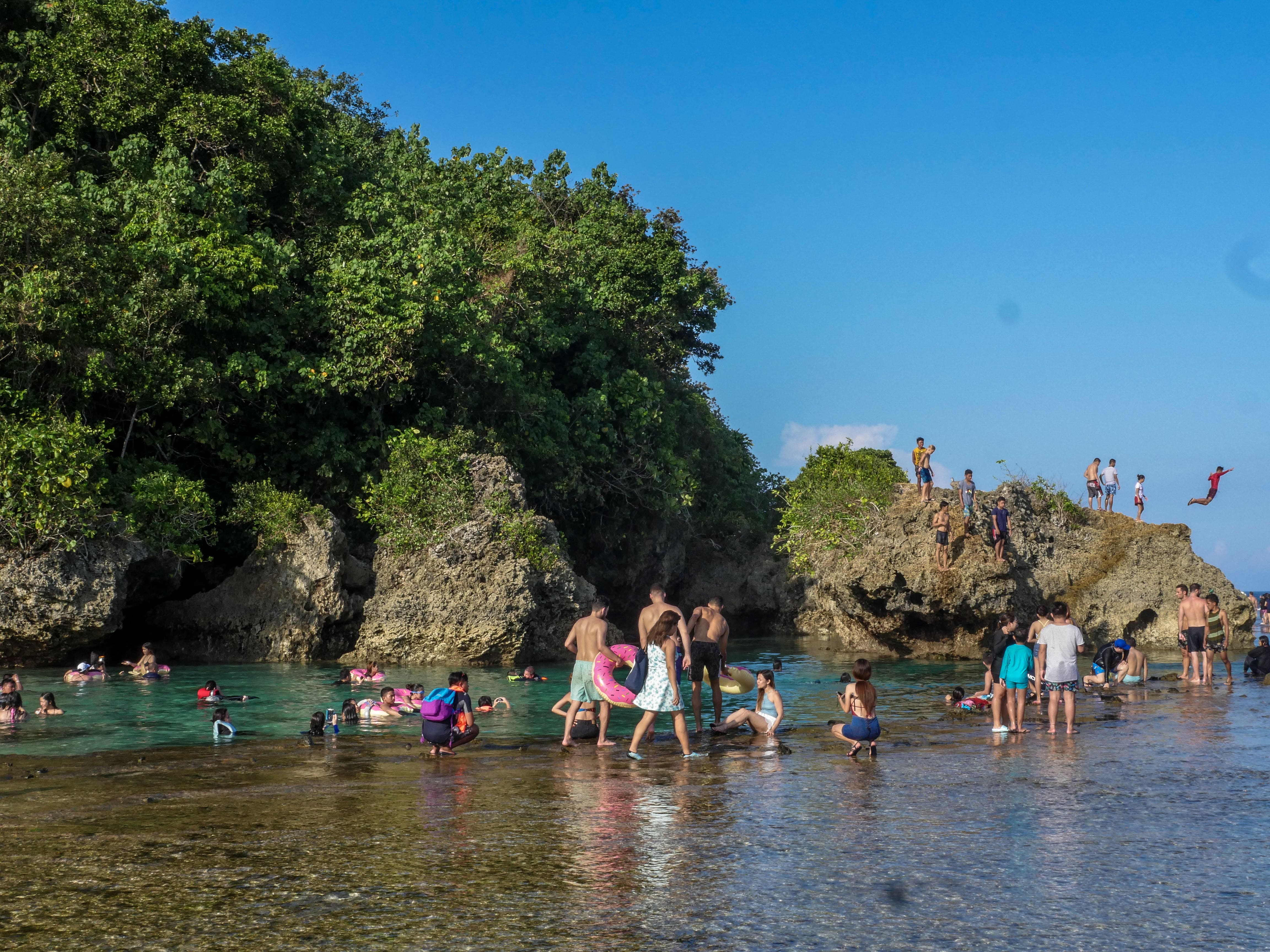 people enjoying themselves at magpupungko rock pools and cliff jumping